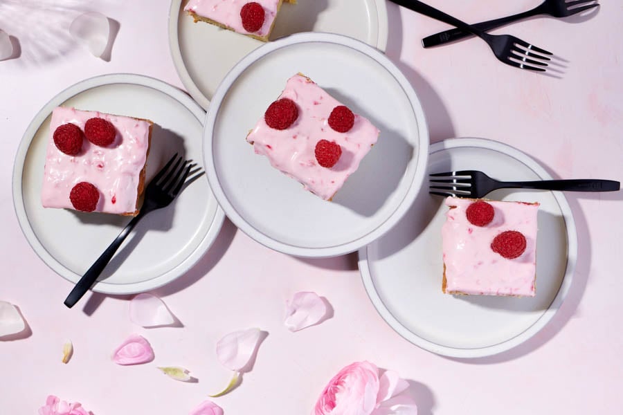 Pink cakes garnished with raspberries by photographer Dina Avila of Portland, Oregon