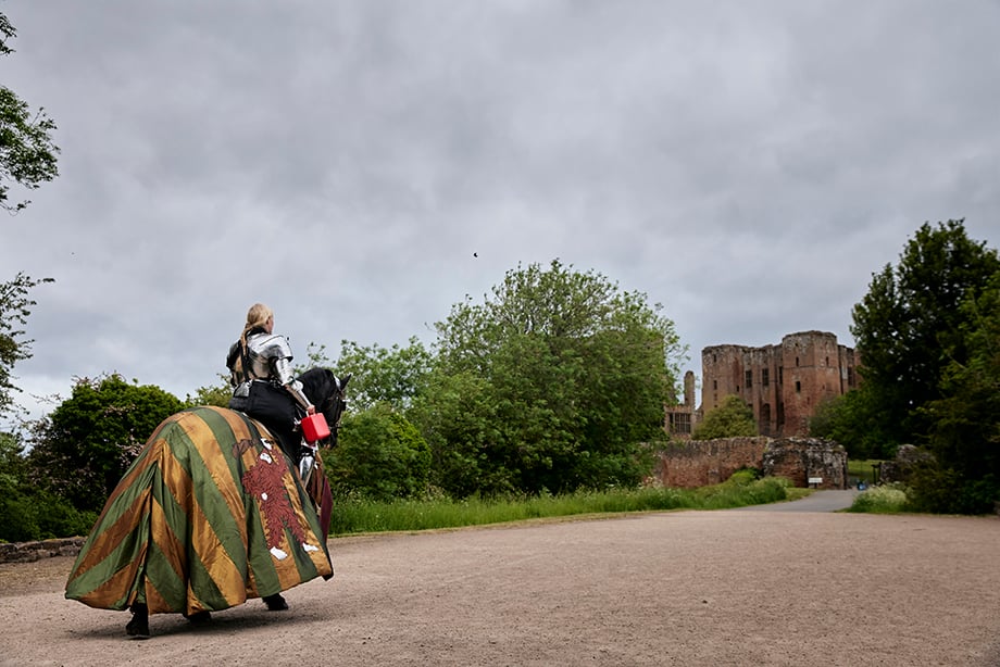 Reenactor jouster in armour with lunchbox on horse shot by Oliver Edwards