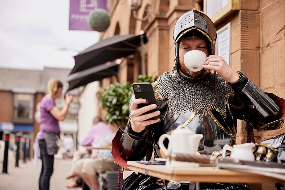 Knight drinking tea at a coffee shop office shot by Oliver Edwards 