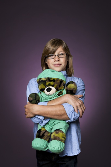 Jack O’Neill, age 9, holds a scrub-wearing Build-A-Bear in honor of his charity, Little Hands Make a Big Difference.