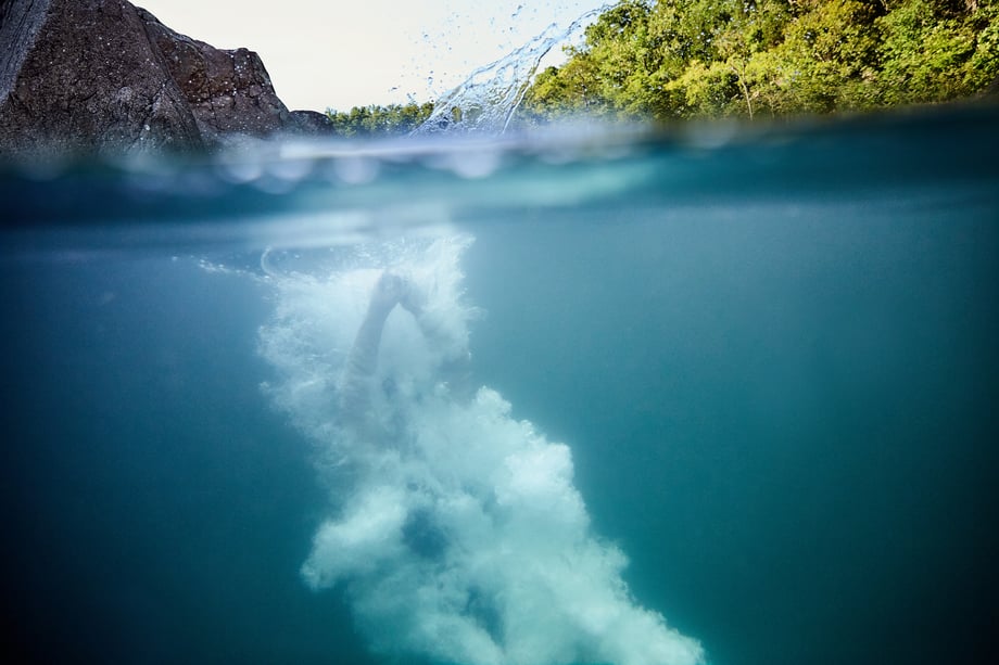 Jay Fram's underwater shot is captured just as a cliff jumper hits the water