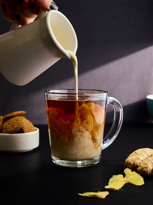 Pouring milk into ginger tea shot by Dhanraj Emanuel
