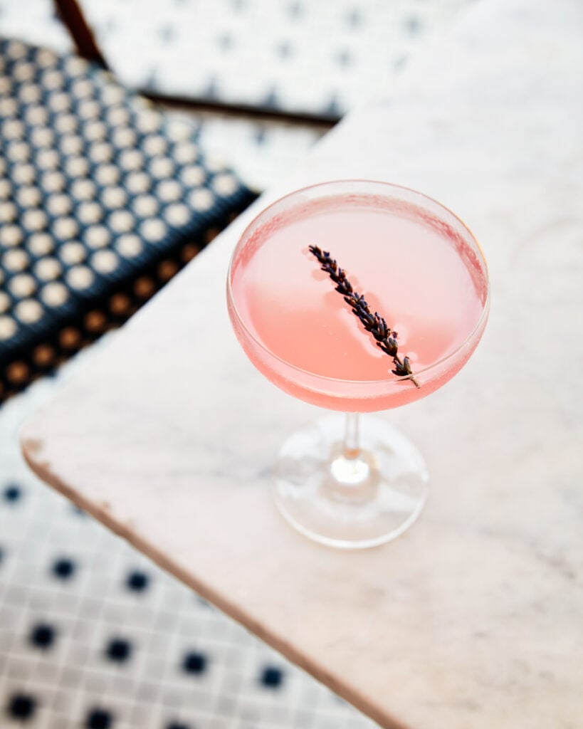 A pink cocktail with dried lavender on top by Joe Schmelzer of Los Angeles, California