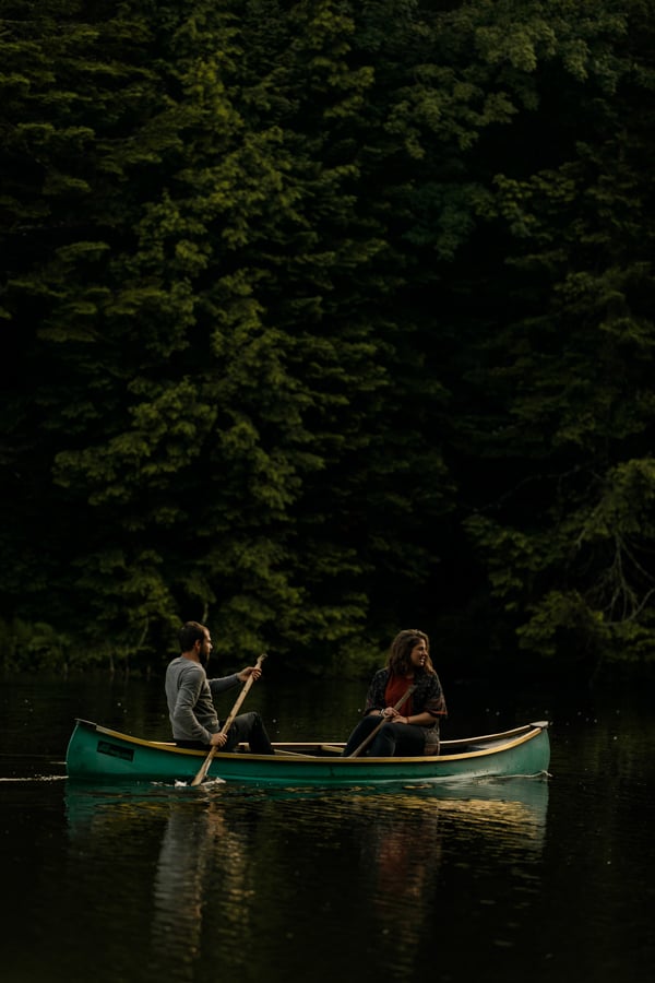 Portrait of two canoers on pine tree lake by Montreal, Canada-based photographer Julien Cadena.