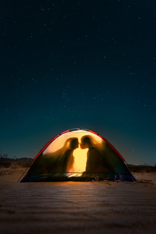 Portrait of two backlit figures in a tent under a starry sky by Indianapolis, Indiana-based photographer Katelin Kinney.