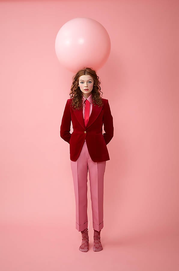 A woman against a pink backdrop with a pink ball on her head by photographer Lindsay Dowell of Atlanta, Georgia 
