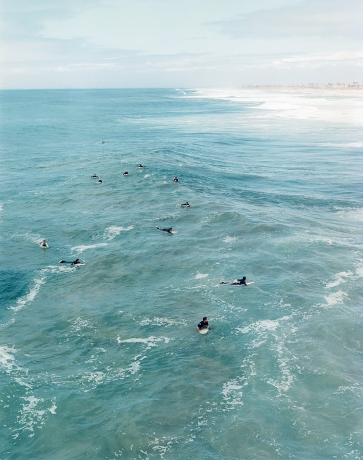 an aerial view of multiple aurfers in the ocean in Orange County, California by photographer Markus Altmann of Berlin, Germany. 