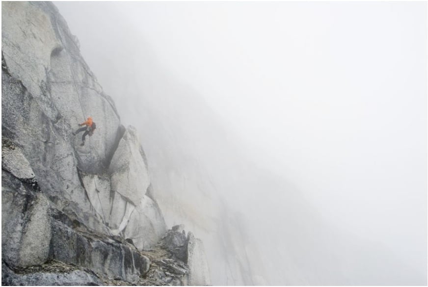 Mountain climber in action and fog shot by Anchorage, Alaska-based landscape photographer Dan Bailey