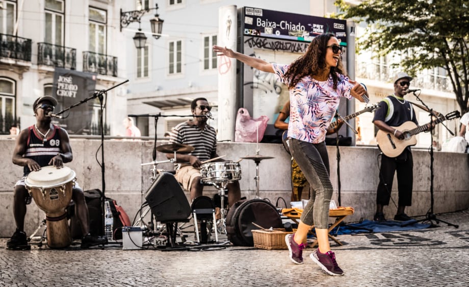 Woman dances as street band performs at Baixa-Chiado metro stop in Lisbon, Portugal. Creative in Place Carry a Tune photographer Olly Bowman, Cham