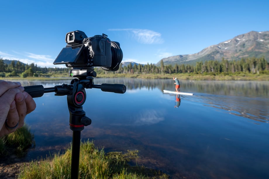 Rachid Dahnoun using Manfrotto gear to take a photo of a man on a stand up paddleboard 