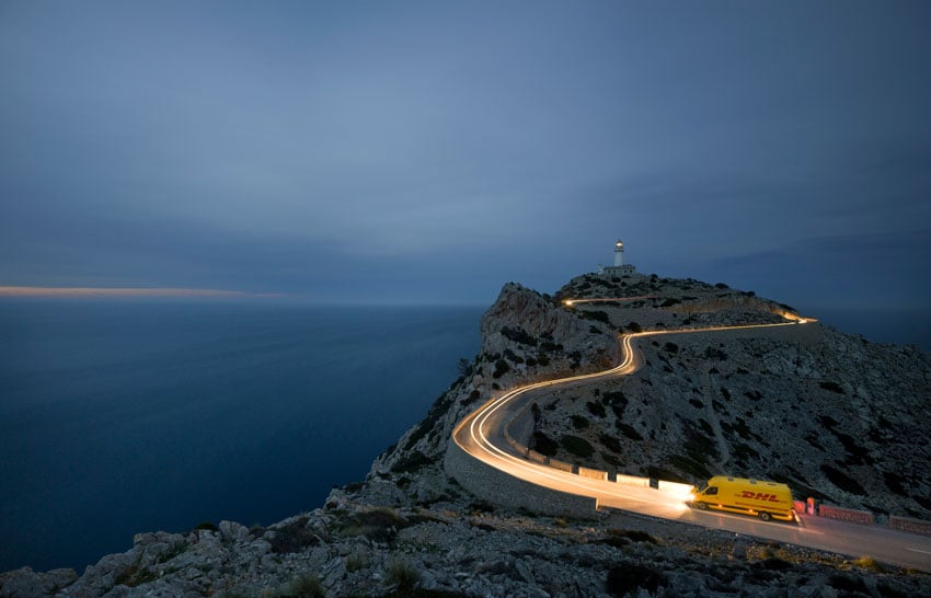 Photo of a truck driving a narrow road to an isolated lighthouse in Mallorca, Spain by Rüdiger Nehmzow