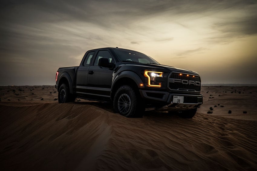 Shea Winter's exploration into auto photography shows a pickup truck parked on a sand dune at dusk
