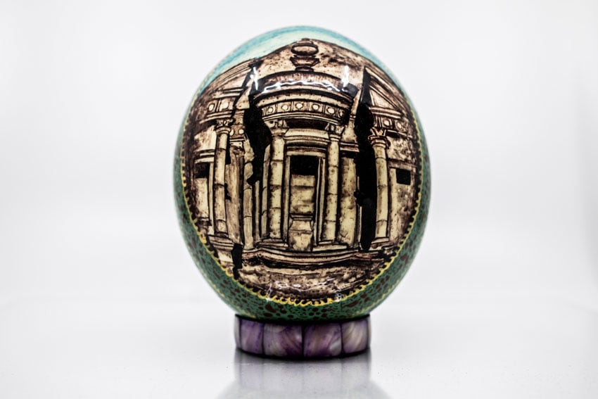 Shea Winter's photo of a stunning, decorative green and gold egg that sits on a pearlescent stand