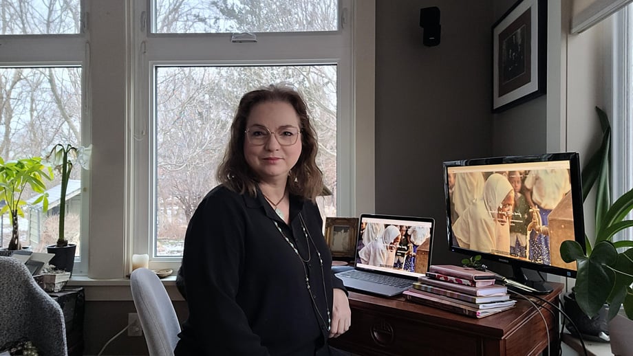 Suzanne working with dual screens in her home office.