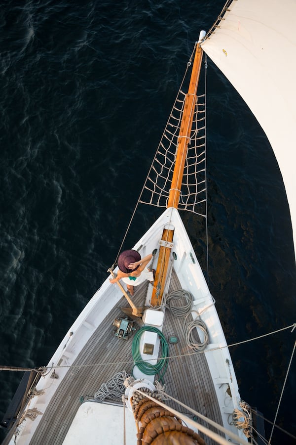An aerial shot of a woman doing the Rose Dawson on the front of a boat by photographer Tegra Stone Nuess of Seattle, Washington.