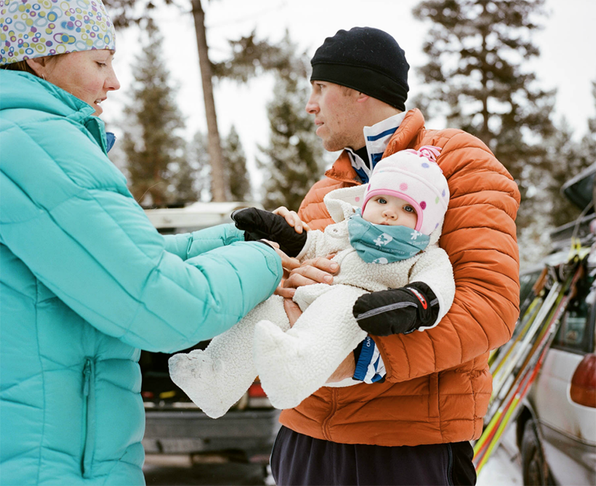 parents and baby wearing winter clothes