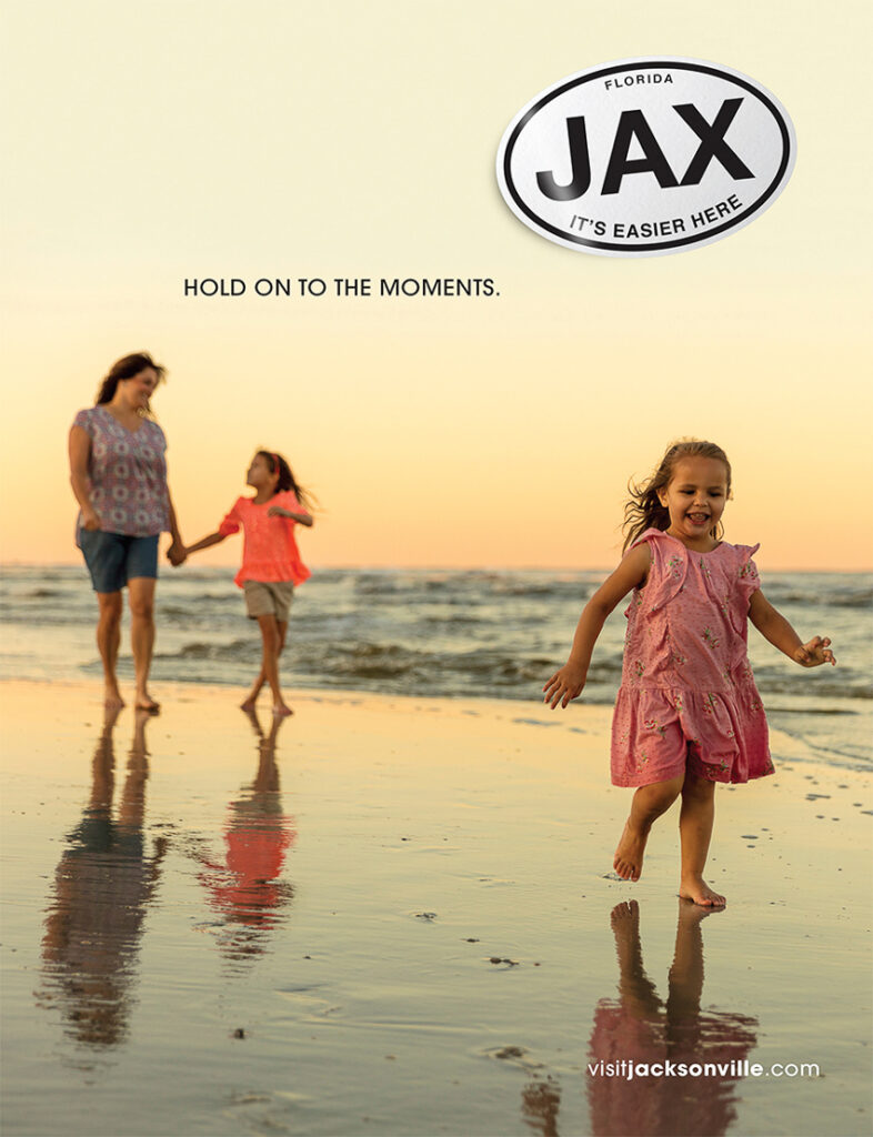 Photo by Ryan Ketterman for Visit Jacksonville of a mother and her two daughters walking along the shore.
