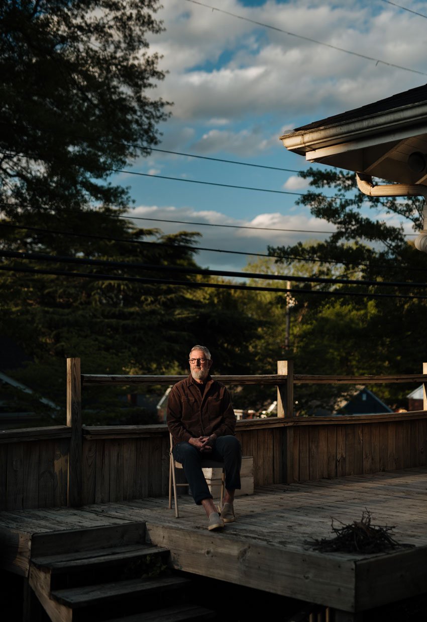 Will Crooks' friend, Jeffrey, sits on a chair on a deck, feeling sad