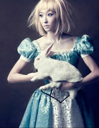 Woman dressed as Alice in Wonderland, holding a bunny, shot by photographer Dean Alexander