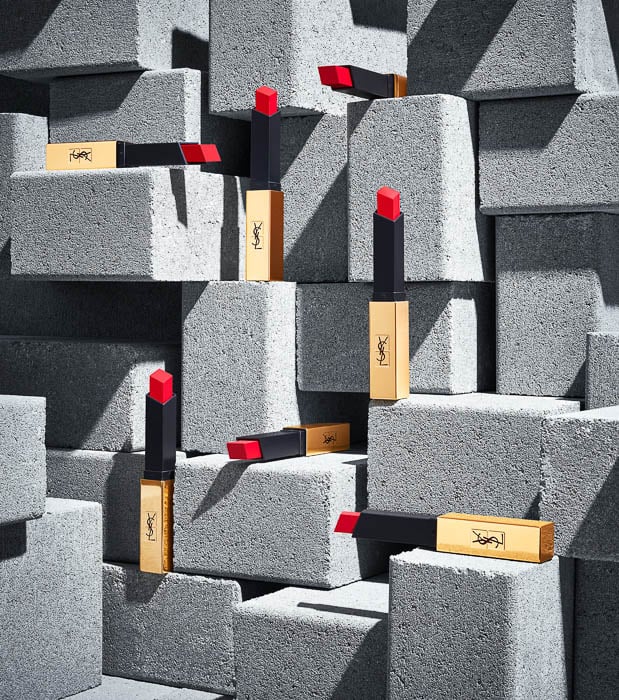 Photo of red YSL lipstick tubes sitting on top of grey concrete blocks taken by Boston-based product photographer Adam Krauth.