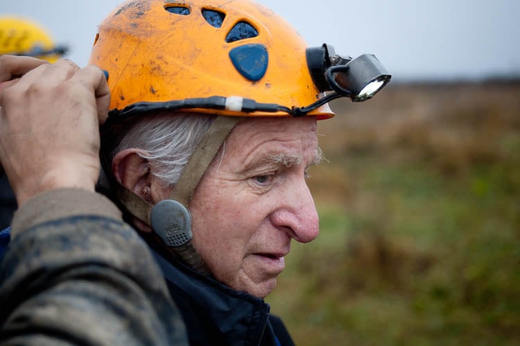 Close up photo of a man having his safety gear adjusted before entering the cave in Ukraine.