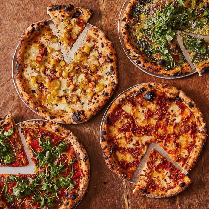 Photo of various pizzas from above taken by New York-based food photographer Alex Sewald. 