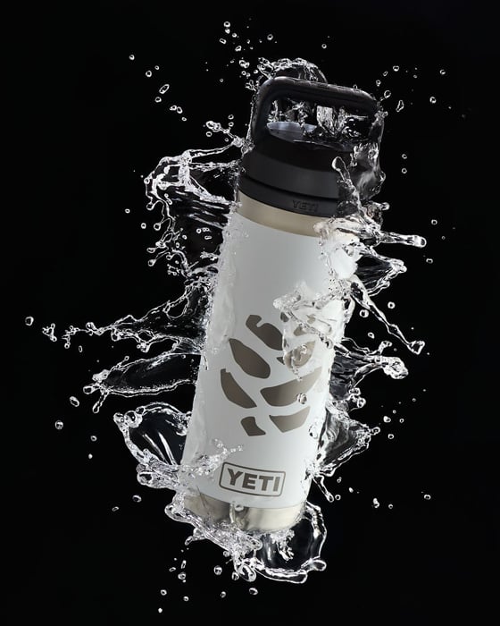 Photo of a Yeti water bottle with liquids splashing around it taken by New York-based product photographer Amy Roth. 