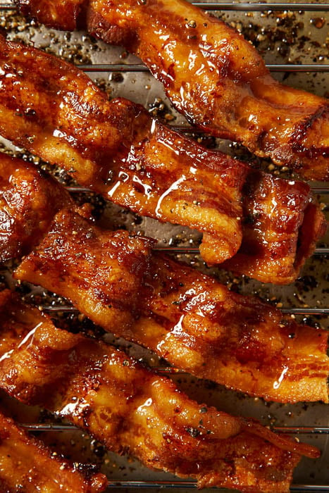 Close-up photo of sizzling bacon strips taken by Los Angeles-based food photographer Andrea D'Agosto. 