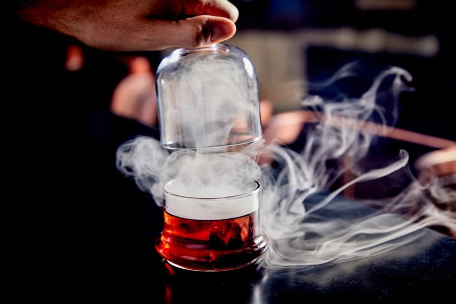 Andrea D'Agosto's shot of a steaming beverage in clear glass at the bar at the Edition hotel