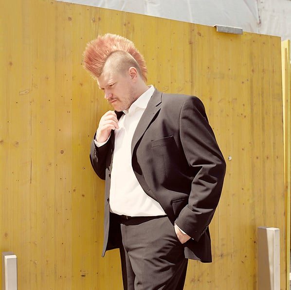 A photo of a suited man with a mohawk by Germany-based portrait photographer Andreas Chudowski.