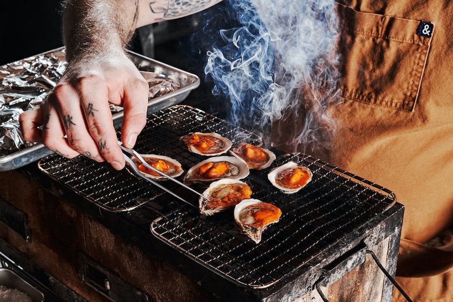 Photo of figure grilling oysters, by Atlanta food photographer Andrew Thomas Lee.