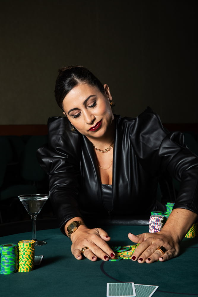 Photo of Reem Assil collecting poker chips taken by Angela DeCenzo. 