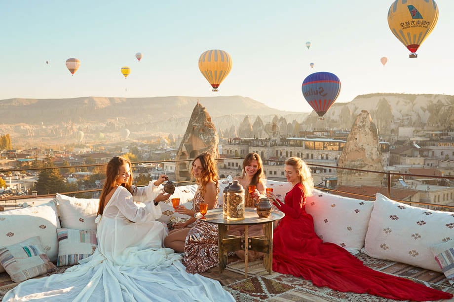 Photo of some female friends enjoying a drink on the Hena Hotel Cappadocia balcony in Turkey taken by New York-based lifestyle photographer Antonio Cuellar. 