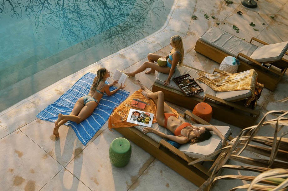 Photo of three women lounging besides a pool taken by Los Angeles-based lifestyle photographer Asami Zenri.