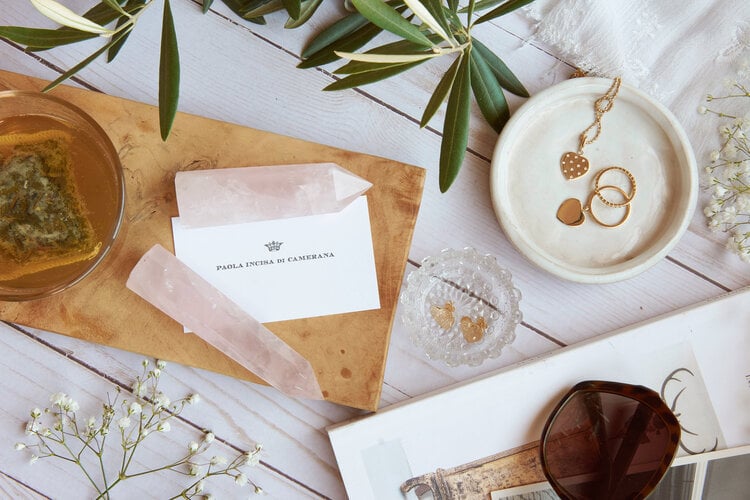 Product photo of gold jewelry, with pink crystals, house plants, and sunglasses, by Los Angeles product photographer Bethany Nauert.