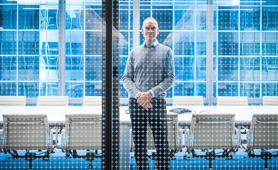 Photo of a CEO behind a glass window taken by Chicago-based corporate photographer Bob Coscarelli. 