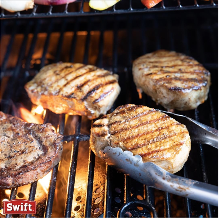 Pork chops on the grille shot by Buff Strickland. 