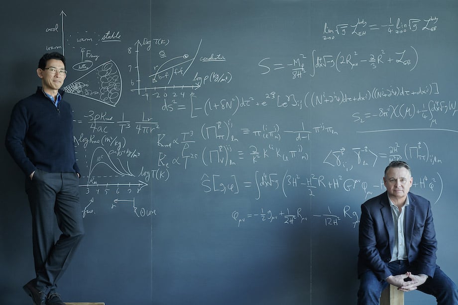 Portrait of two figures before oversized chalkboard marked-up with equations, by Philadelphia corporate photographer Dave Moser.