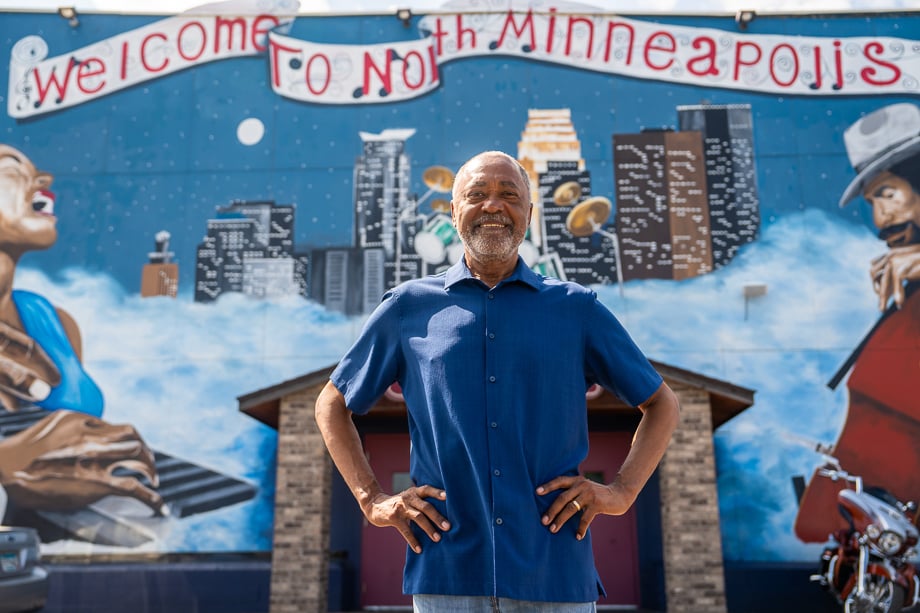 Photo of Don Samuels in front of a North Minneapolis mural taken by David Ellis. 