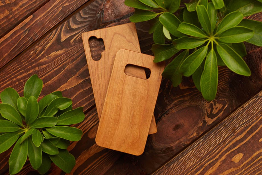 Photo of two wooden smartphone cases resting on a wooden table taken by Miami-based product photographer Debbie Rotman. 