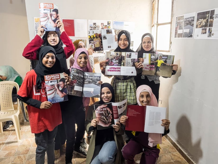 Teenage students from the two-week Ourvoice workshop in Shatila, Lebanon, holding the magazine they published. 