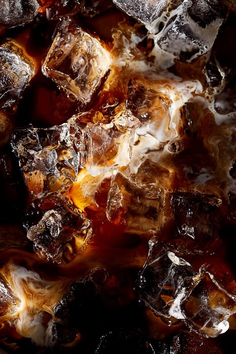 Closeup photo of ice, coffee, and milk taken by New York City-based beverage photographer Evi Abeler. 