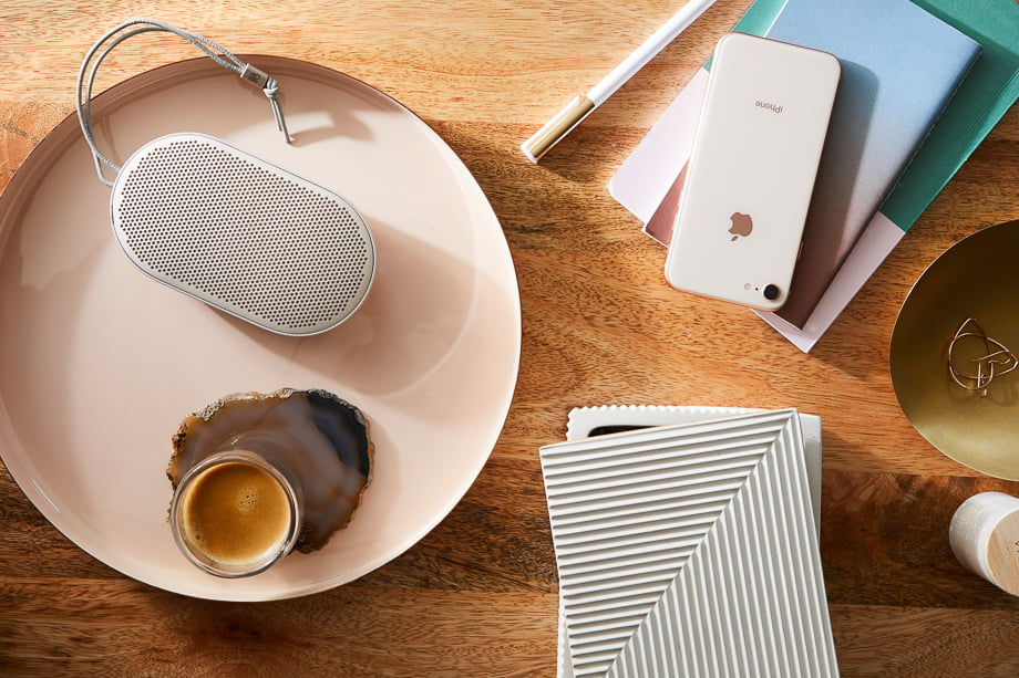 Photo of an iPhone and a wireless bluetooth speaker on a table taken by New York-based product photographer Evi Abeler. 