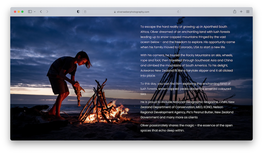Screenshot of Oliver Weber's website showing his bio over an image of a child tending to a bonfire on a beach at dusk.