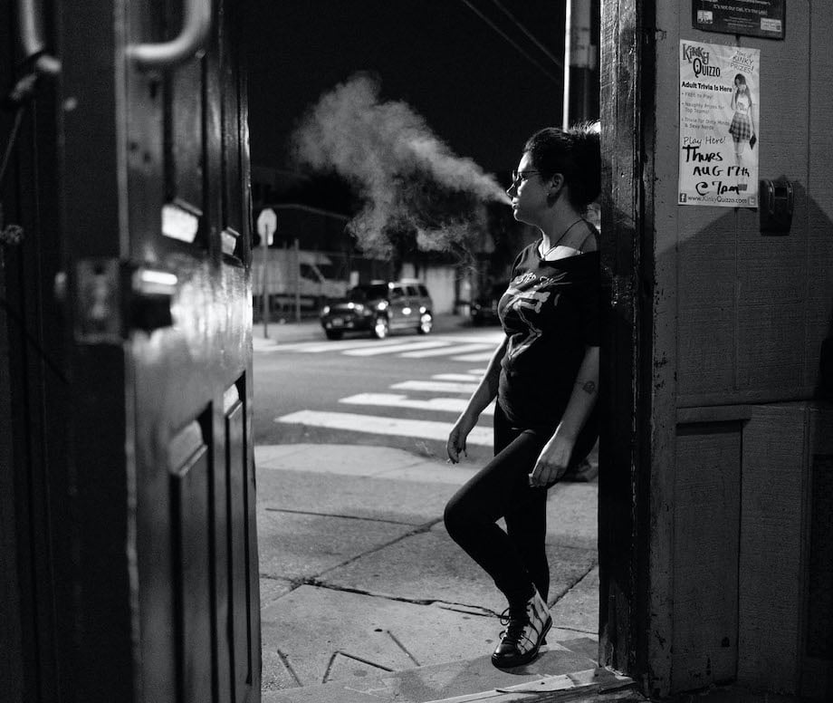 Gene Smirnov won the ASMP award with this black and white image of a person leaning against a wall in a city street. She is blowing smoke out her mouth from the lit cigarette in her hand. Gene has a great strategy for entering photo contests.