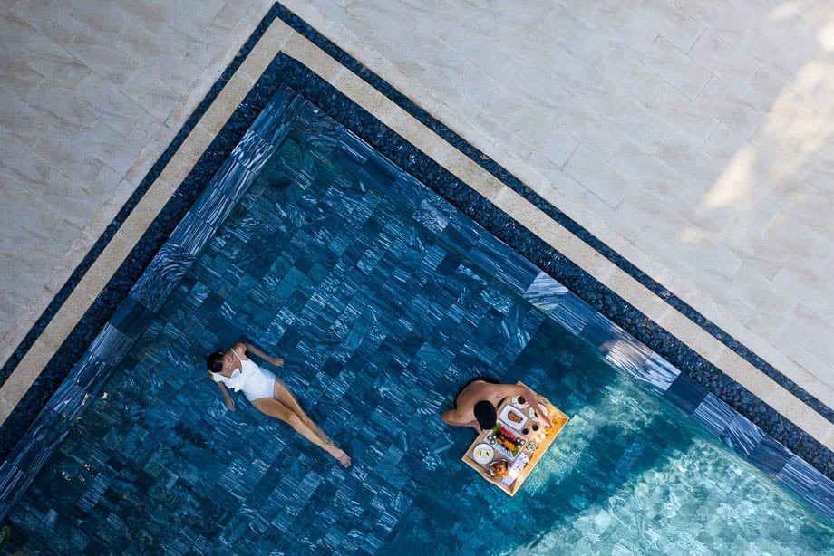 Aerial photo of a couple having a meal in a hotel pool taken by Singapore-based hospitality photographer Felix Hug of Eyes on Asia. 