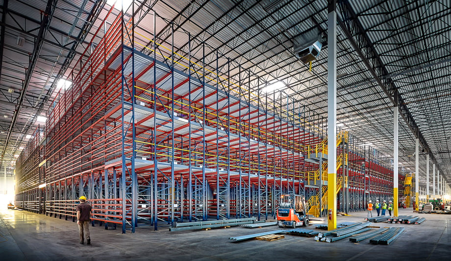 Photo of a large warehouse and people walking around taken by Atlanta-based industrial photographer Gregory Campbell. 