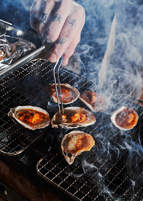 The grilling of clams, shot by food photographer Andrew Lee's for Locust restaurant, in Nashville Tenn.