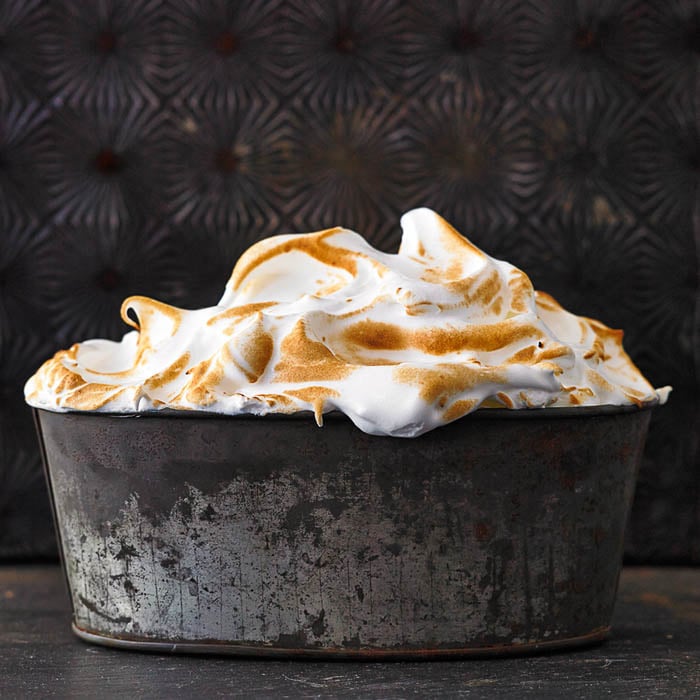 Photo of whipped cream frosting in a tub taken by Boston-based food photographer Heath Robbins. 