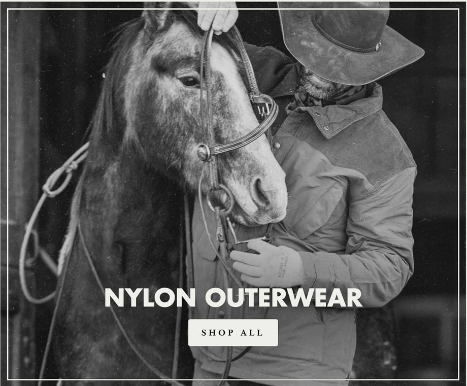 Schaefer Outfitter website screenshot showing a man wearing nylon outerwear while adjusting his horse's harness. 
